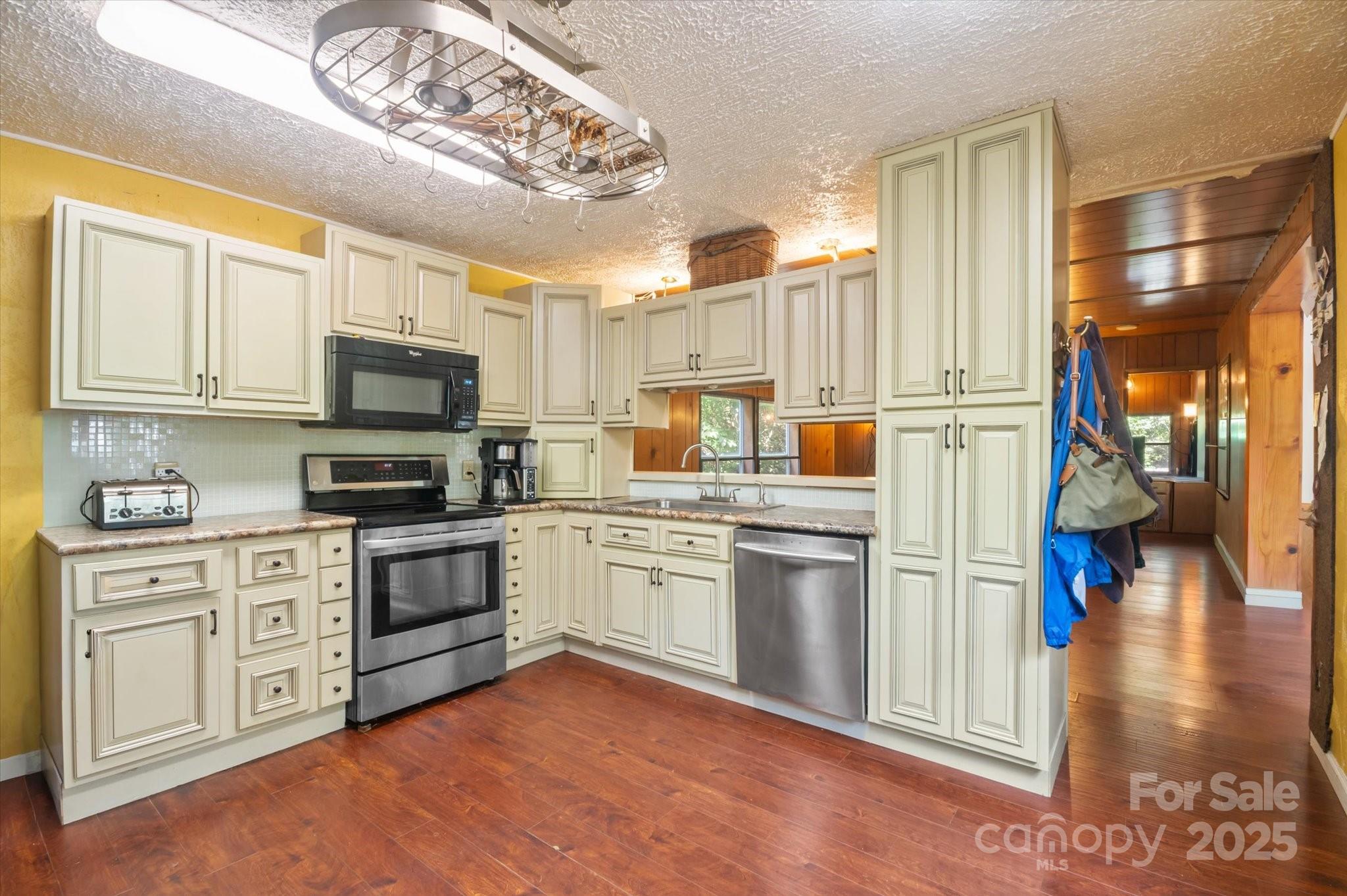 7 Maple Drive Brevard, NC 28712 - Photo 21 of 31 a kitchen with cabinets and wooden floor