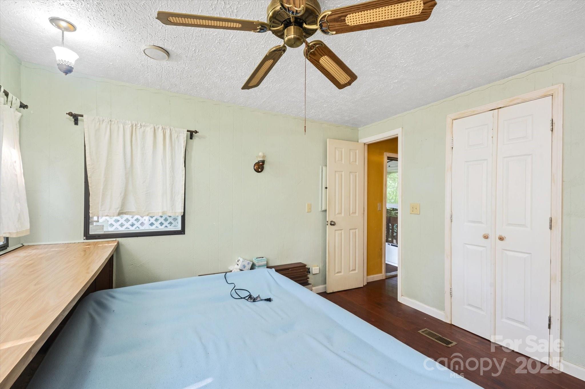 7 Maple Drive Brevard, NC 28712 - Photo 24 of 31 a bedroom with a bed and a chandelier