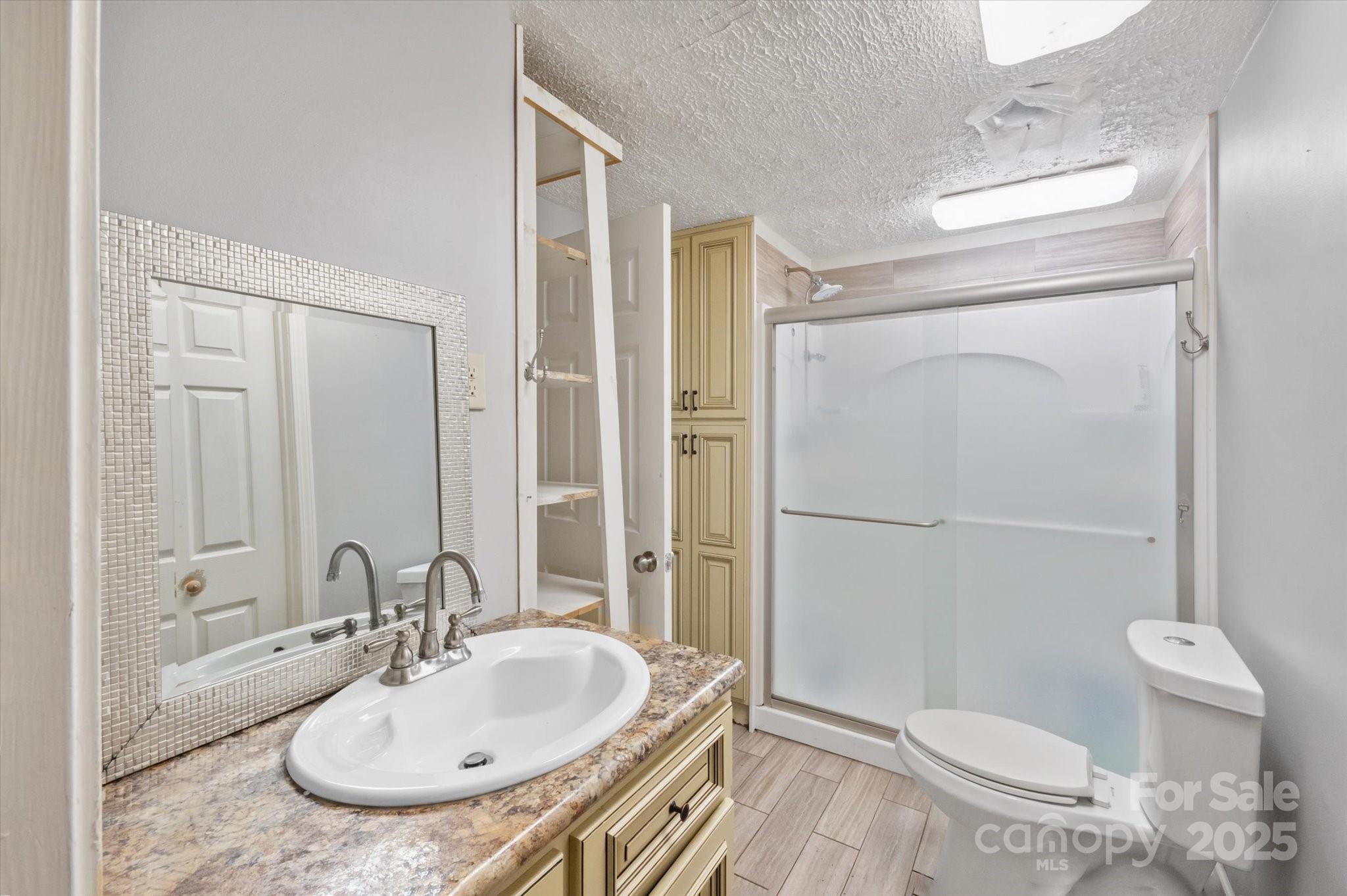 7 Maple Drive Brevard, NC 28712 - Photo 25 of 31 a bathroom with a sink toilet and shower
