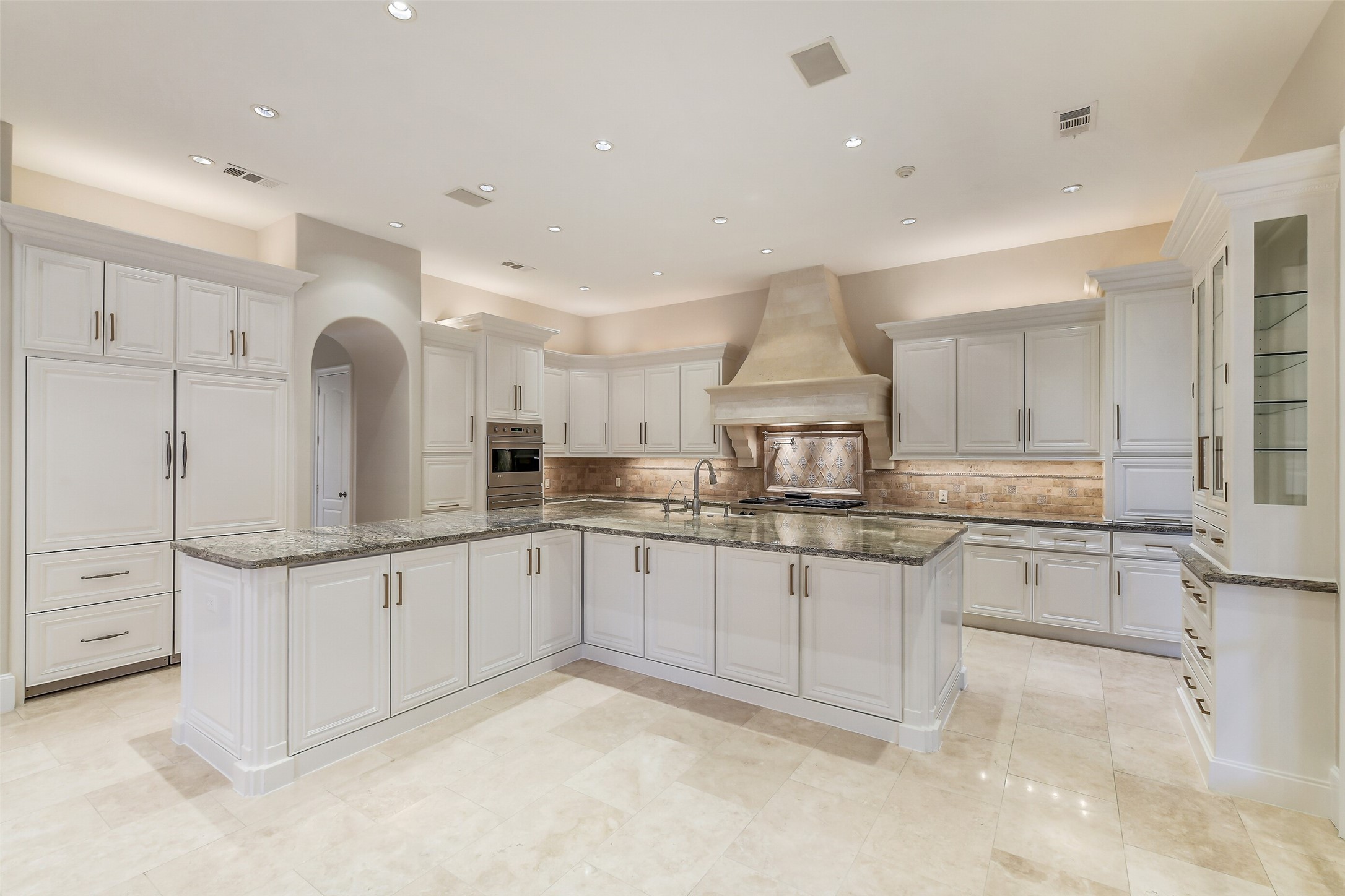 5626 Terwilliger Way Houston, TX 77056 - Photo 10 of 47 a kitchen with granite countertop a sink and white cabinets