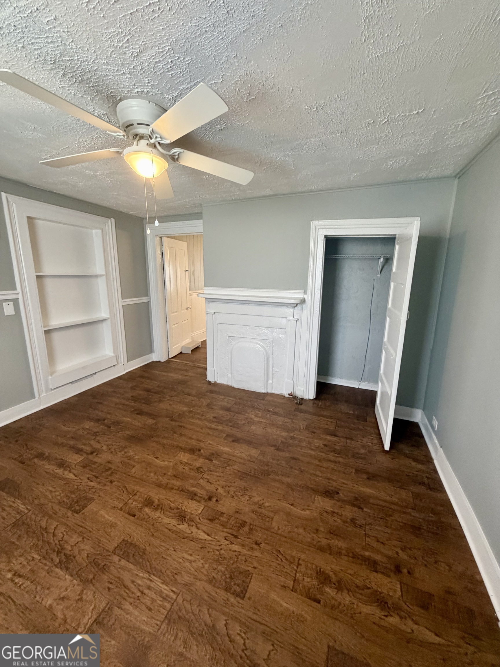 666 Woolfolk Street Macon, GA 31217 - Photo 20 of 60 a view of empty room with wooden floor and fan