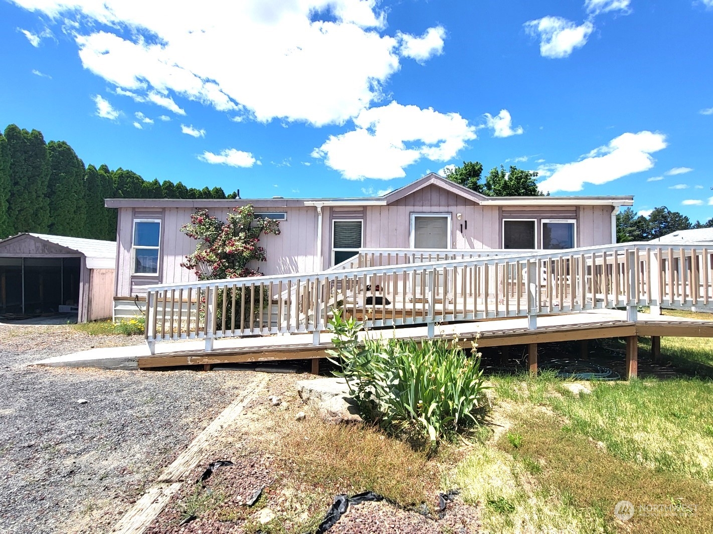 2285 Basin Street Southwest, Unit 11 Ephrata, WA 98823 - Photo 1 of 27 a view of a house with a wooden deck and a yard