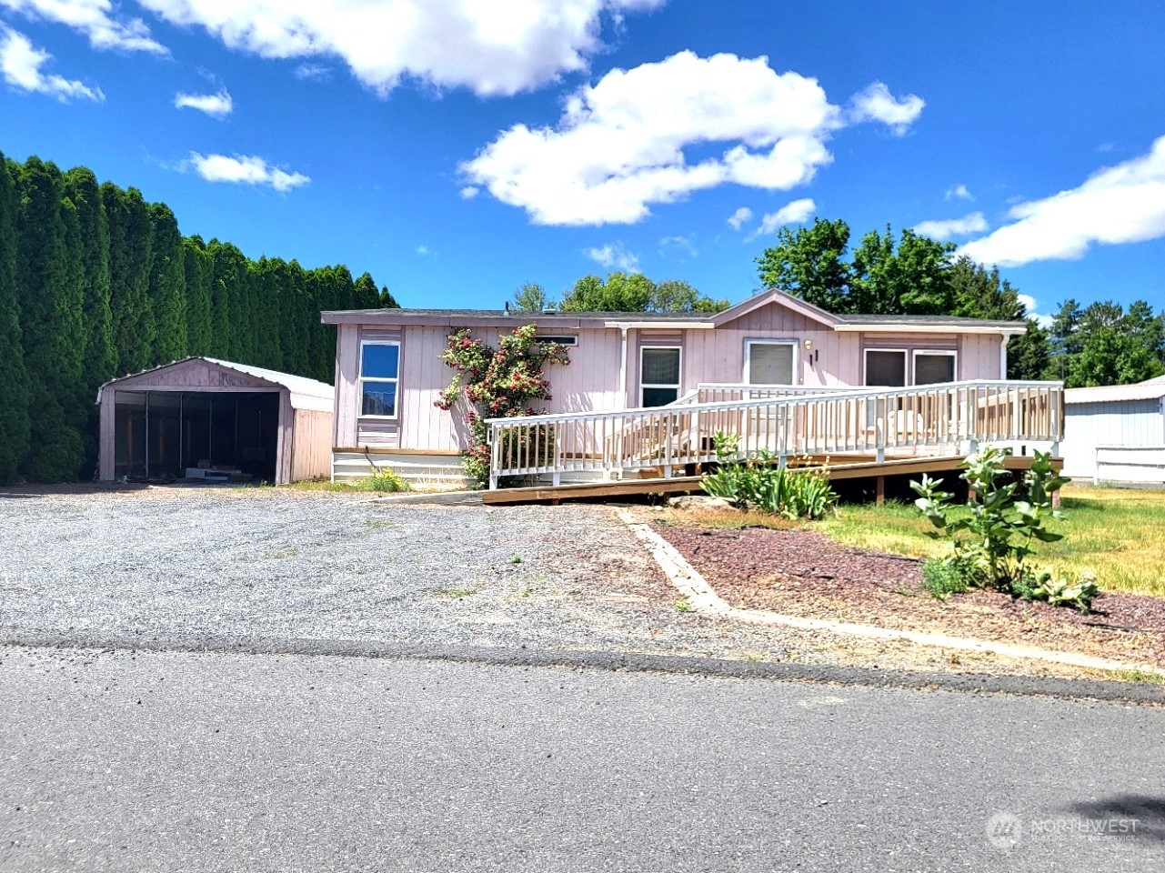 2285 Basin Street Southwest, Unit 11 Ephrata, WA 98823 - Photo 2 of 27 a front view of a house with a yard and potted plants