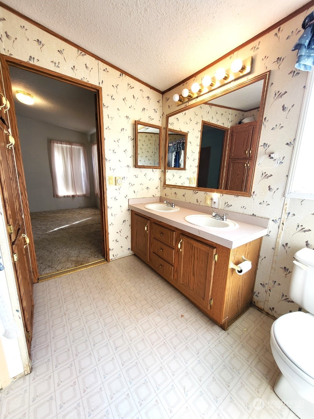 2285 Basin Street Southwest, Unit 11 Ephrata, WA 98823 - Photo 21 of 27 a bathroom with a double vanity sink toilet and mirror