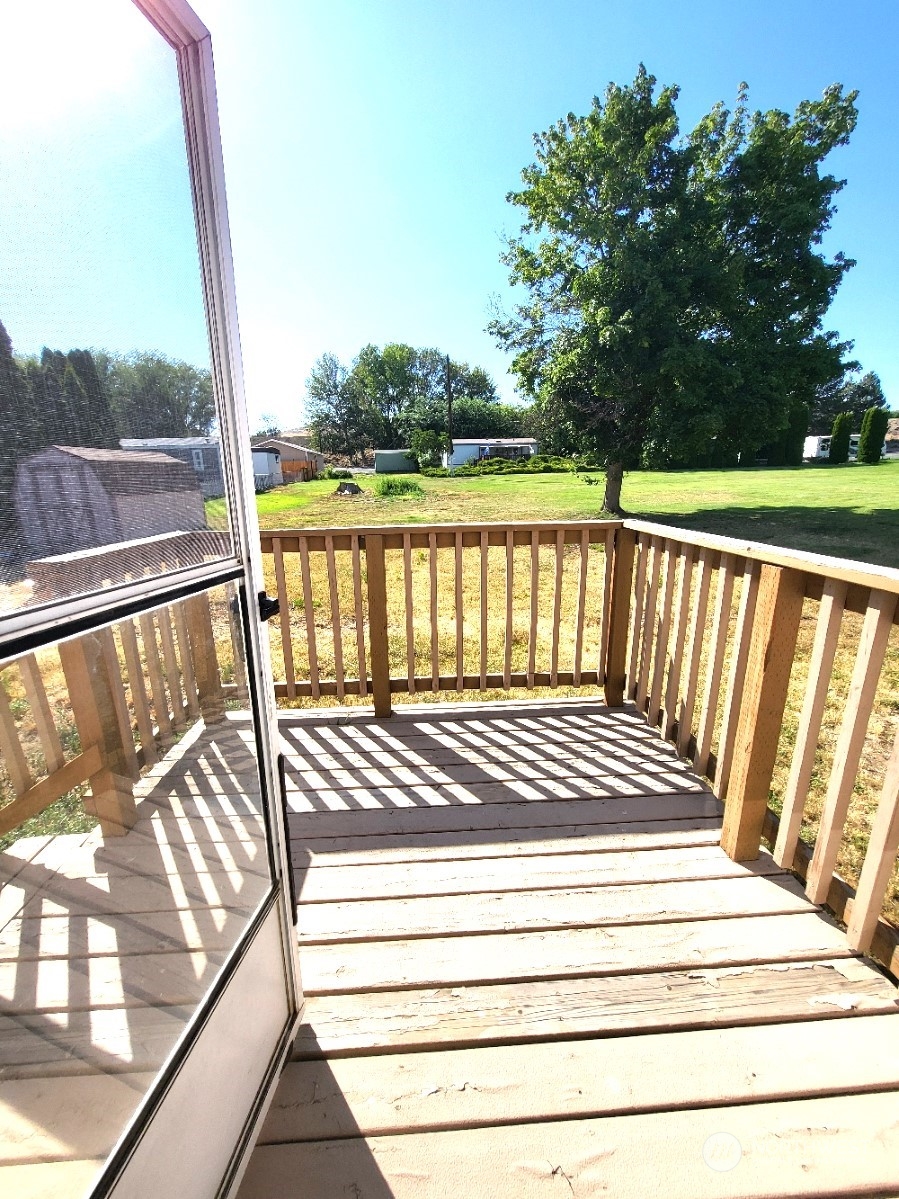 2285 Basin Street Southwest, Unit 11 Ephrata, WA 98823 - Photo 24 of 27 a view of balcony with wooden floor and fence
