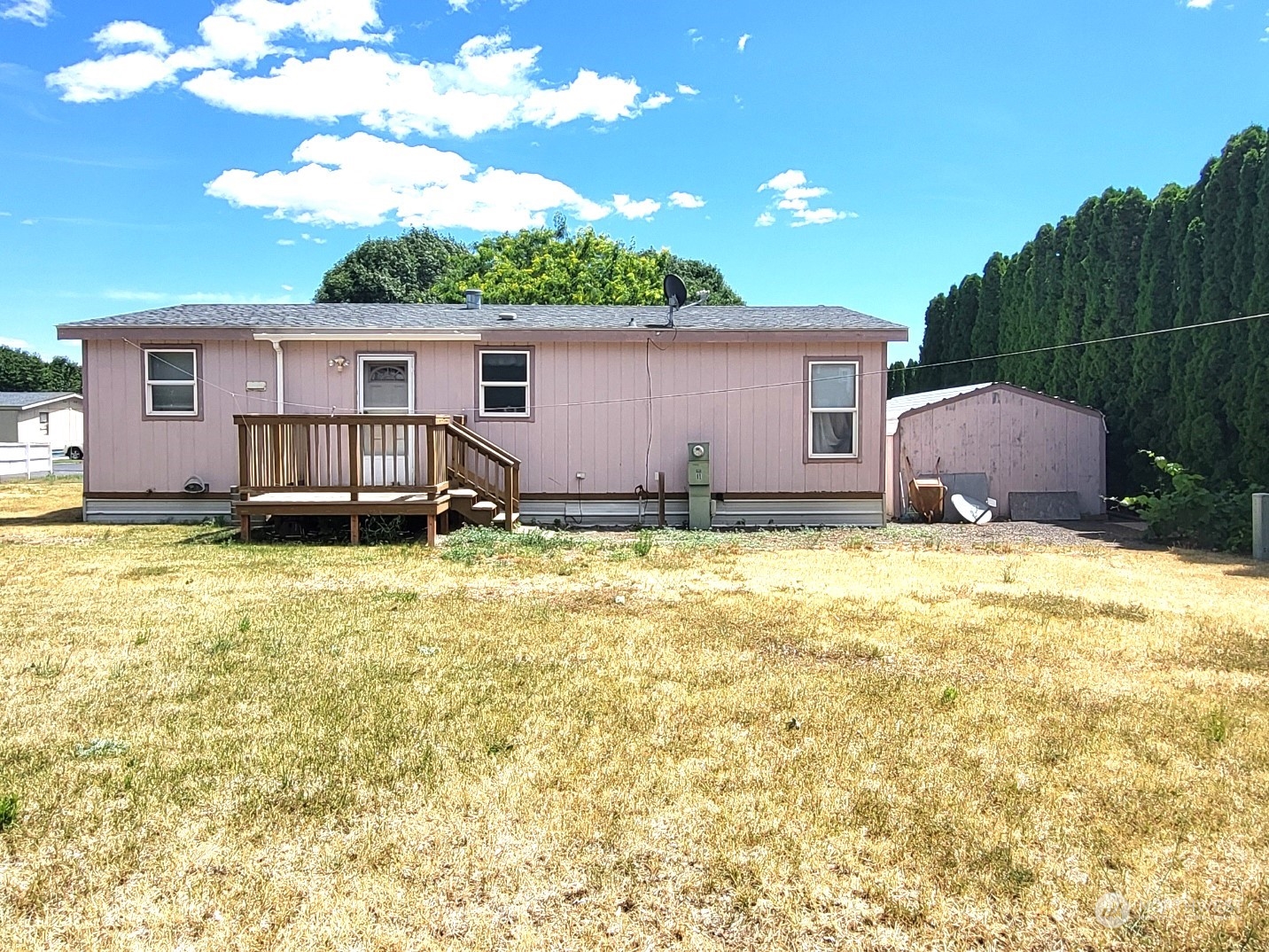 2285 Basin Street Southwest, Unit 11 Ephrata, WA 98823 - Photo 25 of 27 a view of a backyard with table and chairs and wooden fence