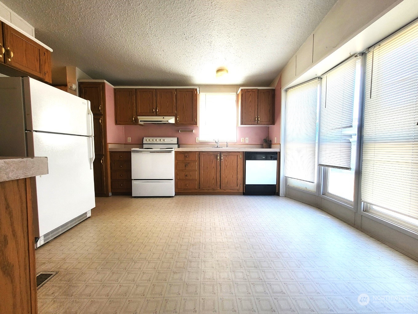 2285 Basin Street Southwest, Unit 11 Ephrata, WA 98823 - Photo 6 of 27 a large kitchen with a large window and a refrigerator