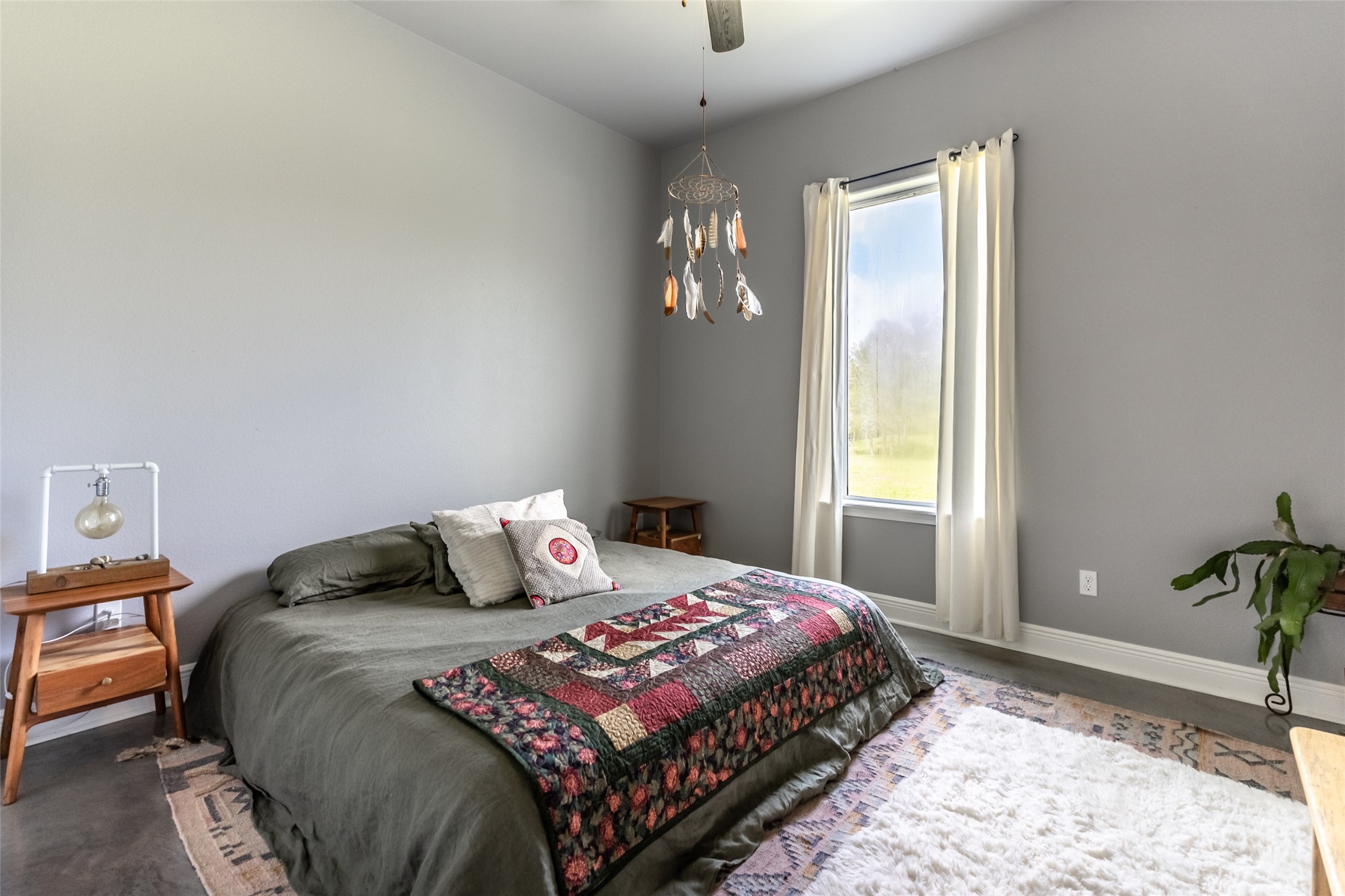 4082 Old Colony Line Road Lockhart, TX 78644 - Photo 12 of 40 A well-lit bedroom with a window offering scenic outdoor views.