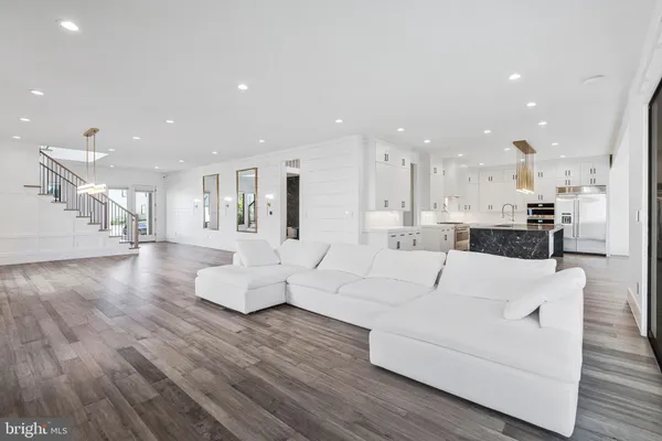 a large kitchen with stainless steel appliances kitchen island granite countertop a large counter top and stove
