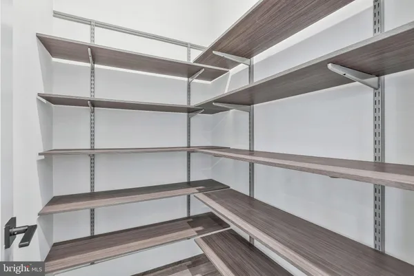 a spacious bedroom with a large bed and wooden floor