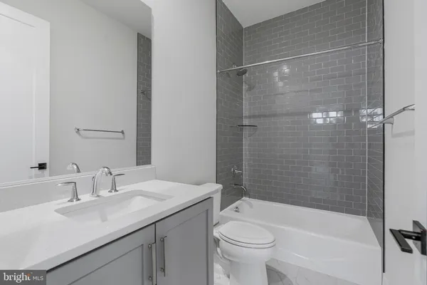 a spacious bathroom with a tub sink shower and mirror