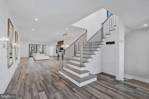a view of entryway and hall with wooden floor