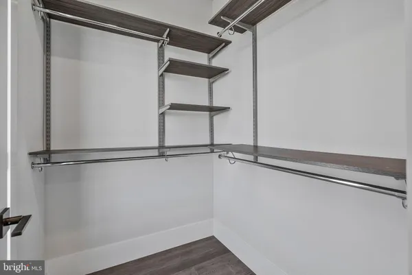 an empty room with windows and mirror