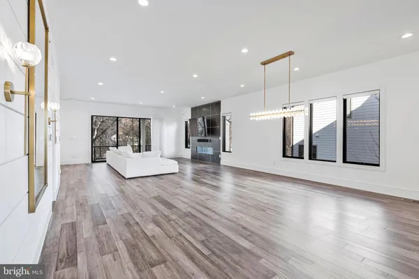 a view of a living room a kitchen and a wooden floor
