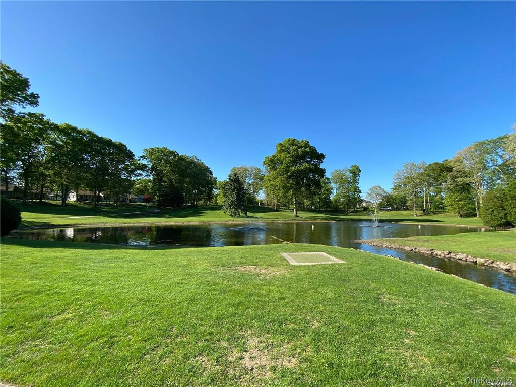 274 Berwick Court, Unit A Ridge, NY 11961 - Photo 29 of 31 View of community featuring a water view and a lawn