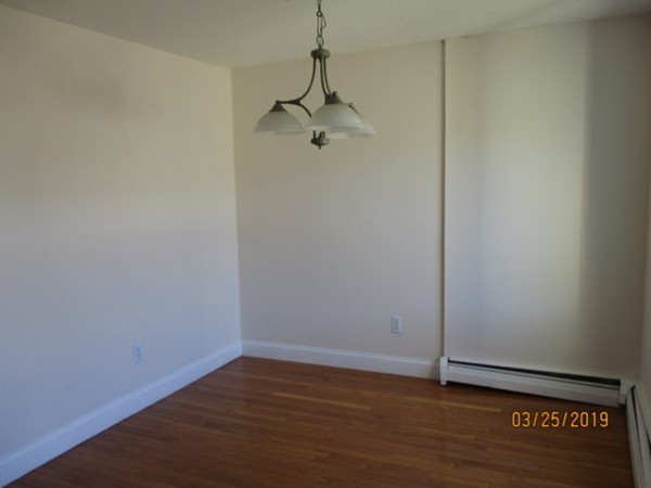 172 Ayer Road, Unit D Shirley, MA 01464 - Photo 2 of 10 a view of a room with wooden floor and a ceiling fan