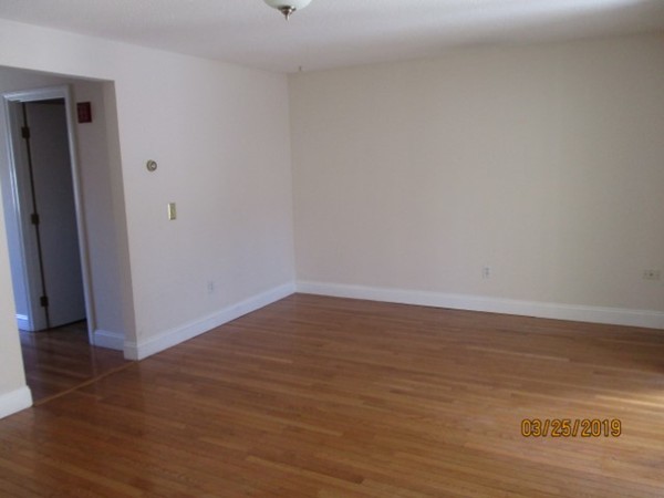 172 Ayer Road, Unit D Shirley, MA 01464 - Photo 4 of 10 a view of a room with wooden floor