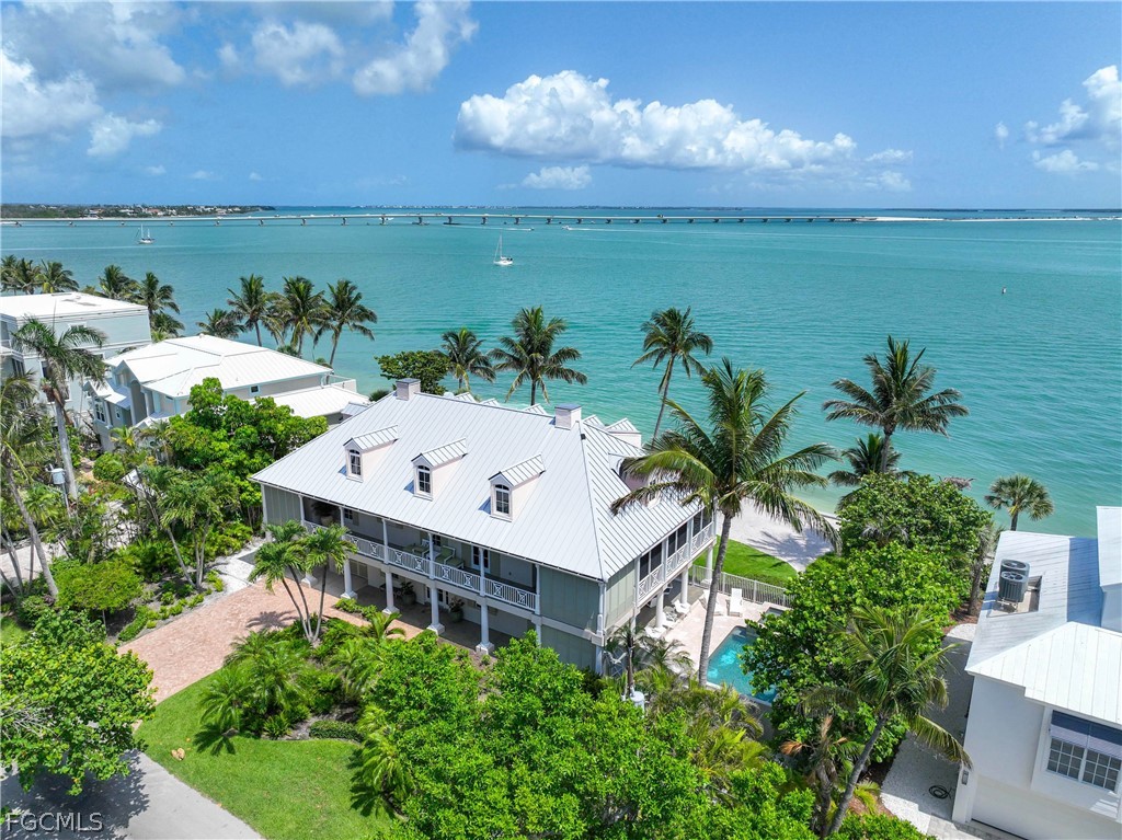 an aerial view of house with yard and ocean view