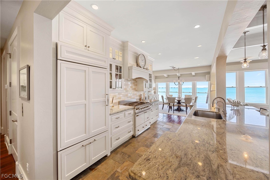 528 Lighthouse Way Sanibel, FL 33957 - Photo 21 of 49 a kitchen with sink refrigerator and cabinets