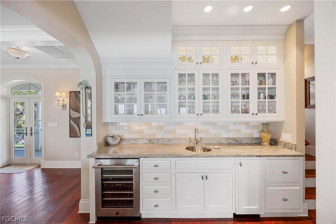 528 Lighthouse Way Sanibel, FL 33957 - Photo 23 of 49 a kitchen with granite countertop white cabinets and stainless steel appliances