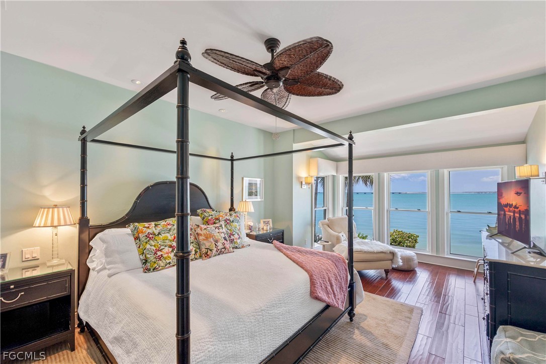 528 Lighthouse Way Sanibel, FL 33957 - Photo 25 of 49 a bedroom with a bed a chandelier and a large window