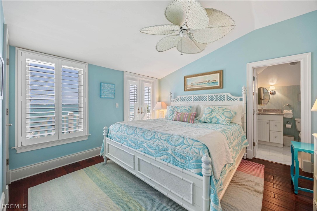 528 Lighthouse Way Sanibel, FL 33957 - Photo 31 of 49 a bedroom with a bed and a chandelier