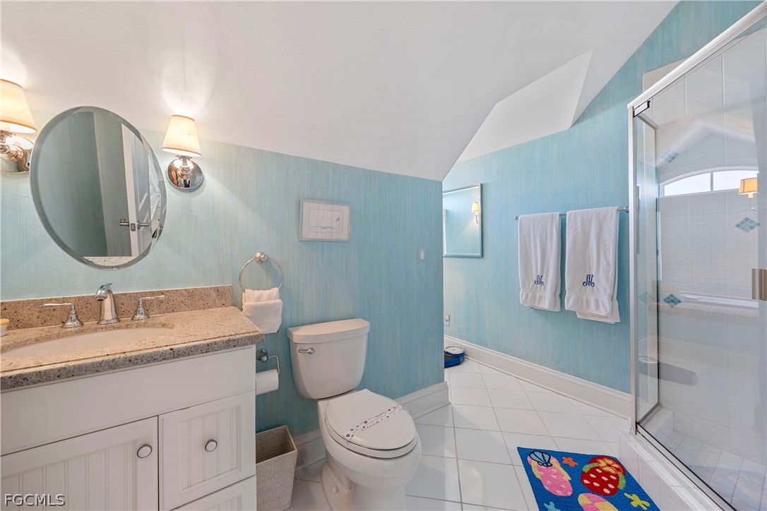 528 Lighthouse Way Sanibel, FL 33957 - Photo 32 of 49 a bathroom with a granite countertop toilet a sink and a mirror