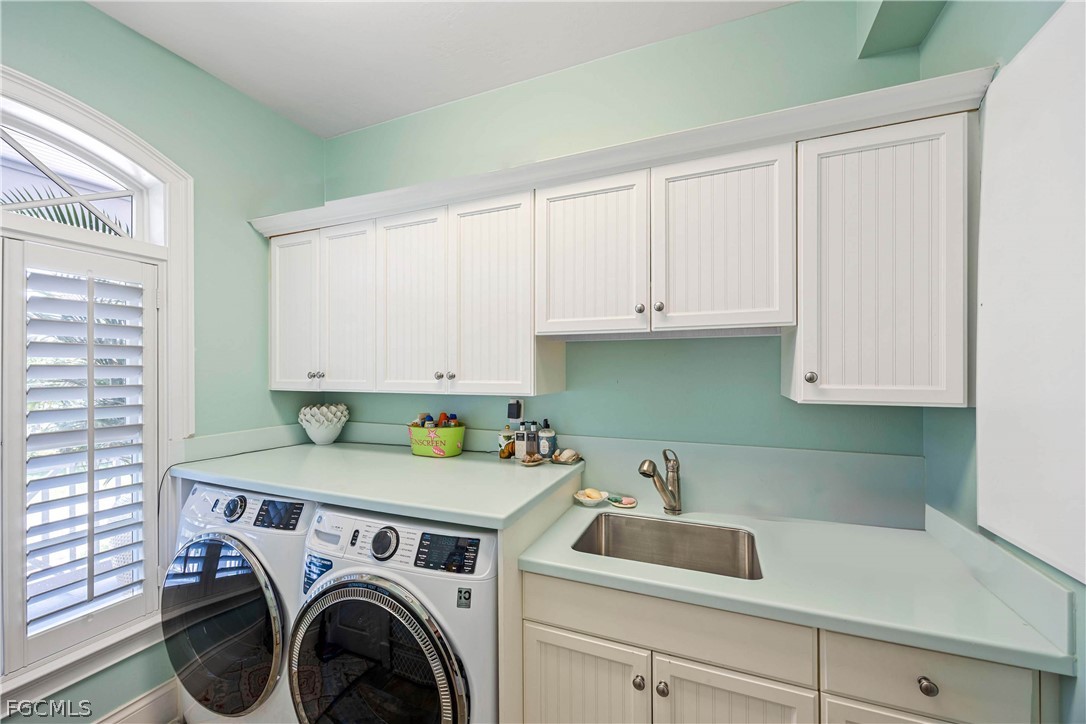 528 Lighthouse Way Sanibel, FL 33957 - Photo 36 of 49 a utility room with sink dryer and washer