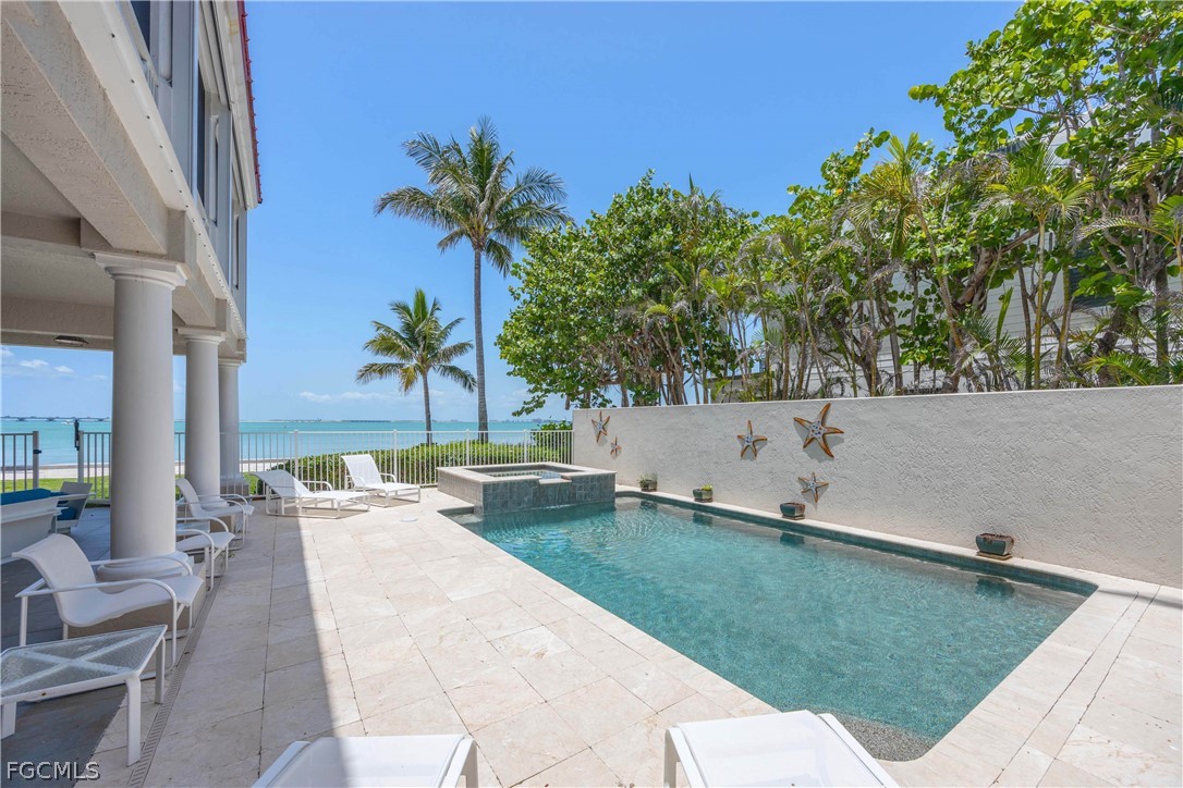 528 Lighthouse Way Sanibel, FL 33957 - Photo 40 of 49 a backyard of a house with table and chairs