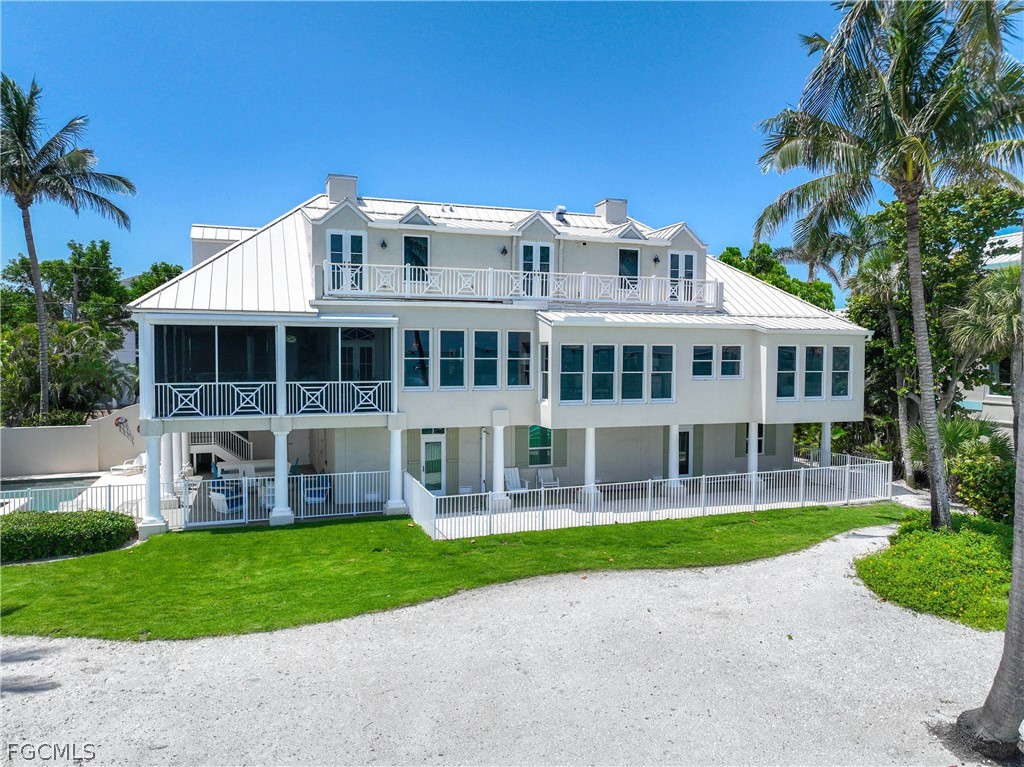 528 Lighthouse Way Sanibel, FL 33957 - Photo 42 of 49 a front view of a house with a yard table and chairs