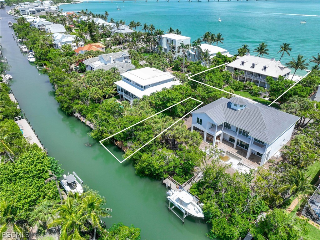 528 Lighthouse Way Sanibel, FL 33957 - Photo 7 of 49 an aerial view of a house with a garden and lake view