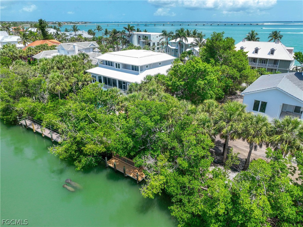 528 Lighthouse Way Sanibel, FL 33957 - Photo 8 of 49 an aerial view of a house with swimming pool and outdoor seating