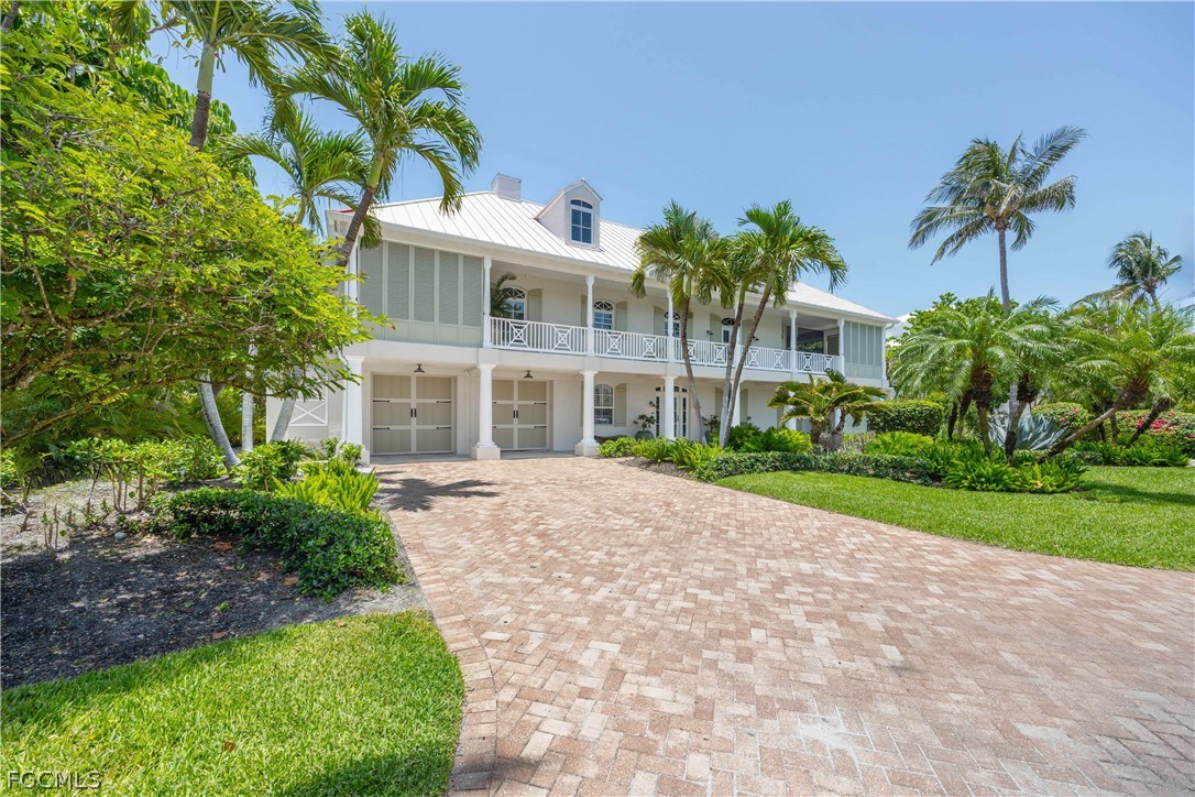 528 Lighthouse Way Sanibel, FL 33957 - Photo 10 of 49 a front view of a house with a yard and potted plants