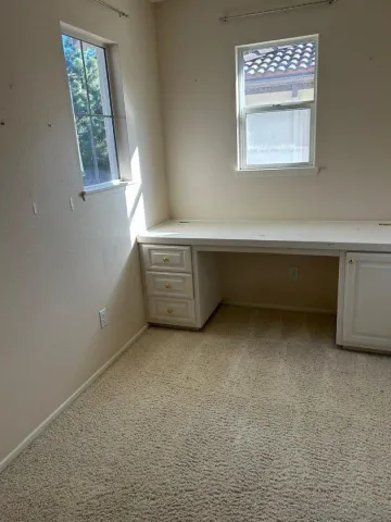 a room with window and cabinet