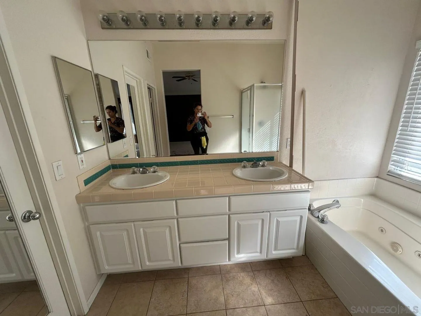 9408 Questa Pointe San Diego, CA 92126 - Photo 7 of 13 a bathroom with a sink and a mirror