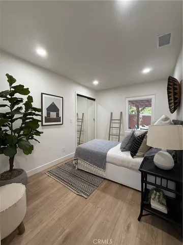 a view of a yard with wooden fence and a large tree