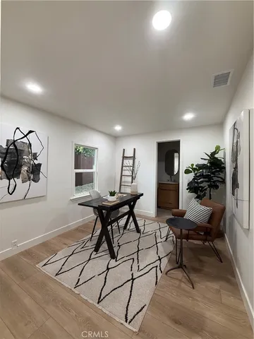 a white house that has a tree in front of it