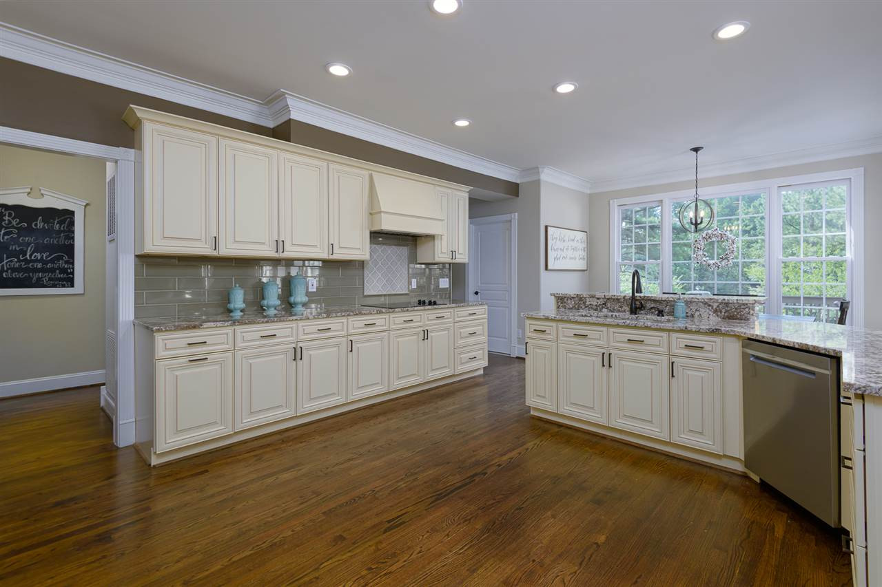1000 Streeter Lane Raleigh, NC 27614 - Photo 11 of 30 a kitchen with kitchen island granite countertop a sink cabinets and wooden floor
