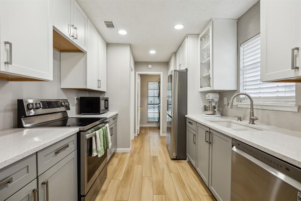 226 East Ridgegate Drive Garland, TX 75040 - Photo 11 of 25 a kitchen with a sink appliances and cabinets