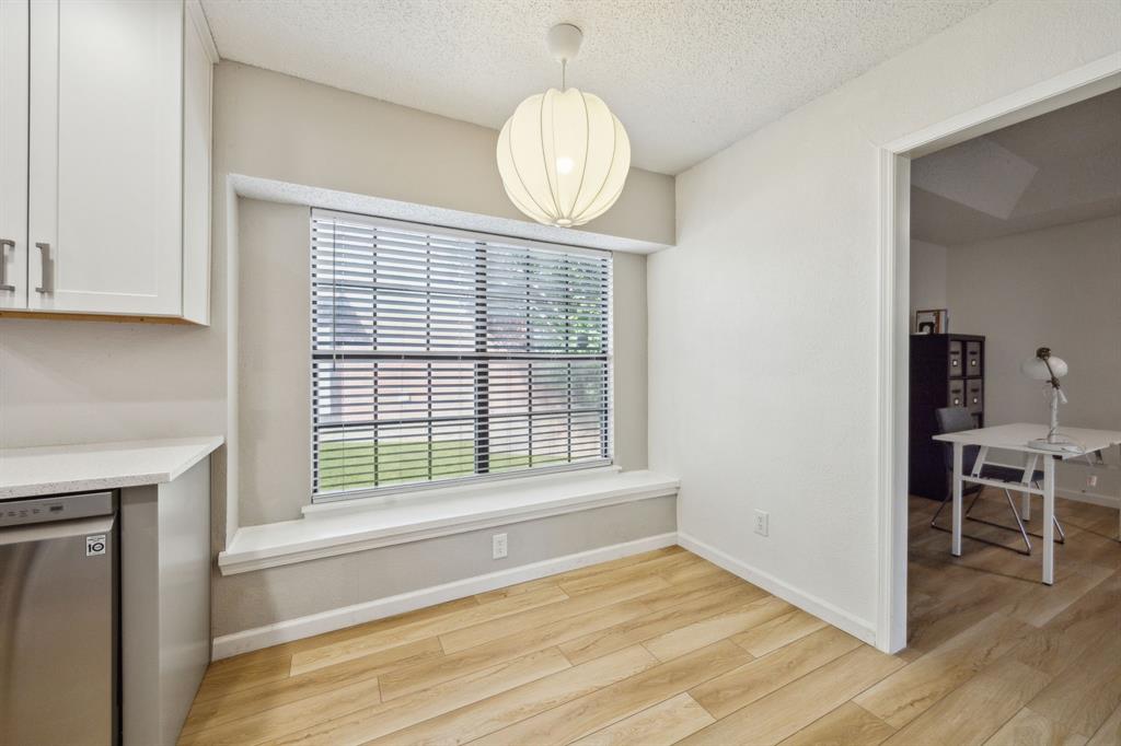 226 East Ridgegate Drive Garland, TX 75040 - Photo 12 of 25 a view of an empty room with wooden floor and a window