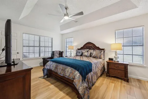 a bedroom with a bed a window and dresser