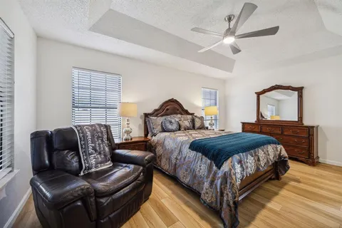 a bedroom with a bed couch and window