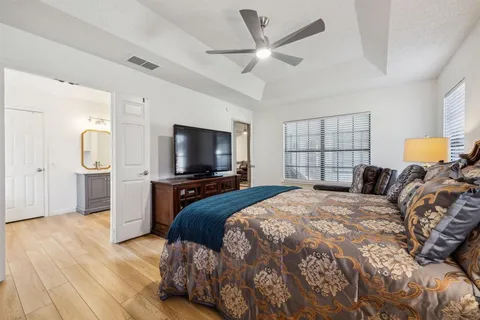 a bedroom with a bed and a flat screen tv