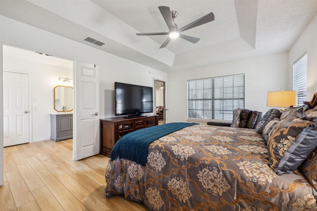 226 East Ridgegate Drive Garland, TX 75040 - Photo 16 of 25 a bedroom with a bed and a flat screen tv