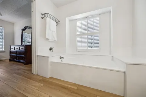 a bathroom with a bathtub and a window