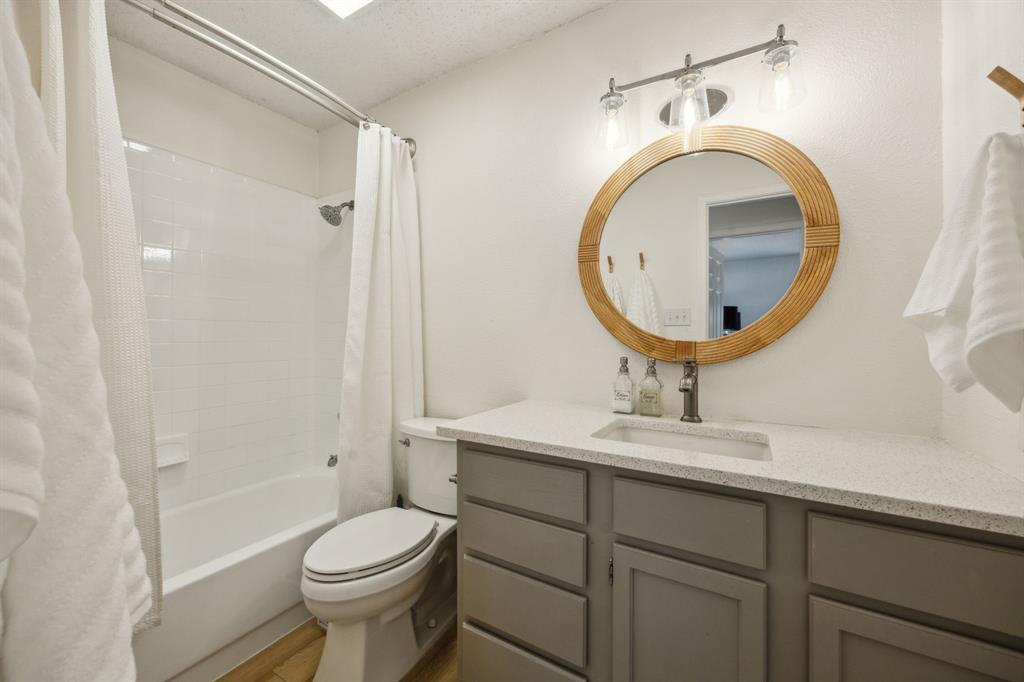 226 East Ridgegate Drive Garland, TX 75040 - Photo 21 of 25 a bathroom with a sink a toilet and a mirror