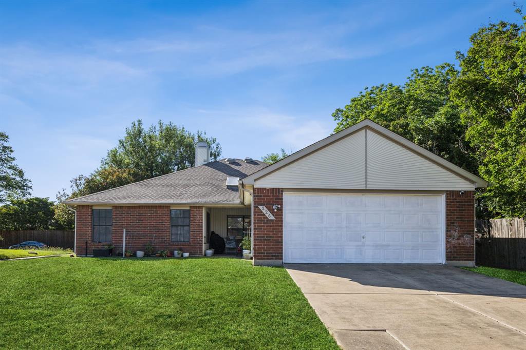 226 East Ridgegate Drive Garland, TX 75040 - Photo 24 of 25 a front view of a house with a yard and garage