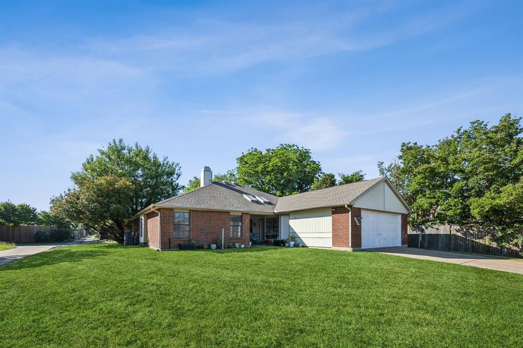 226 East Ridgegate Drive Garland, TX 75040 - Photo 25 of 25 a front view of a house with garden
