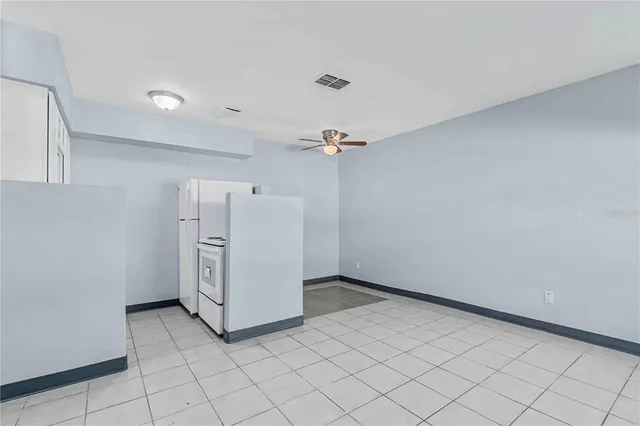 a view of a storage & utility room with refrigerator