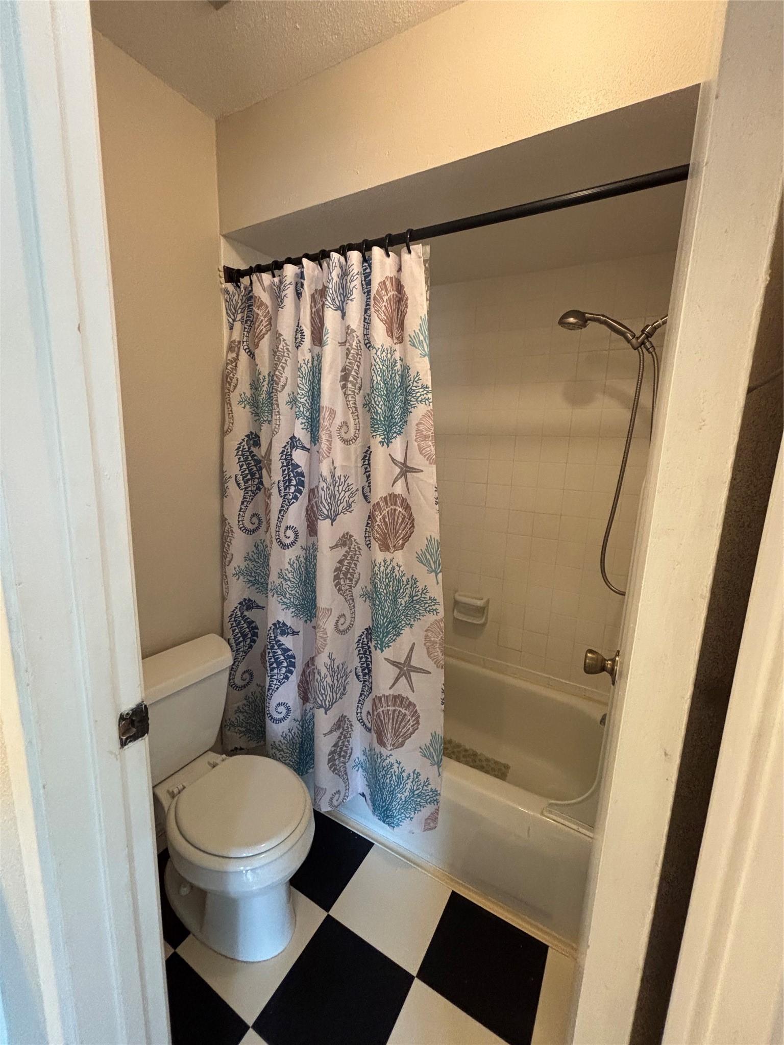 14515 Wunderlich Drive, Unit 315 Houston, TX 77069 - Photo 26 of 37 a bathroom with a toilet and a shower curtain
